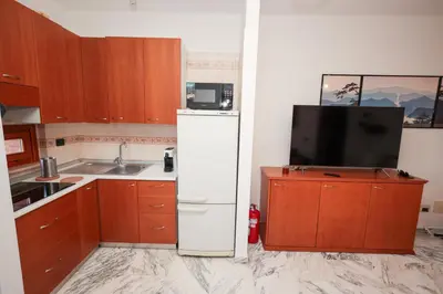 a kitchen with a white refrigerator and a microwave at La Casa di Piero in Rome