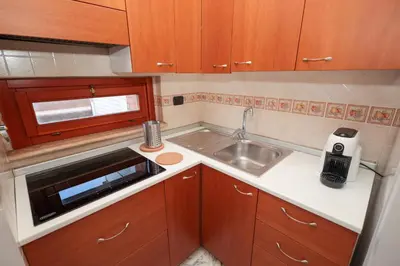 a small kitchen with a sink and a microwave at La Casa di Piero in Rome