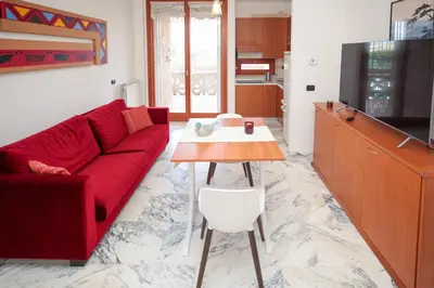 a living room with a red couch and a table at La Casa di Piero in Rome