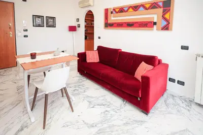 a living room with a red couch and a table at La Casa di Piero in Rome