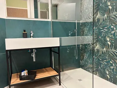 a bathroom with a sink and a shower at Lilium Suites in Rome
