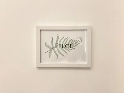 a framed picture of a plant on a wall at Lilium Suites in Rome