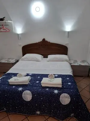 a bedroom with a bed with three towels on it at APARTAMENTO NAPOLEONe 38 in Rome