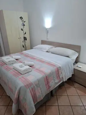 a bedroom with a bed with towels on it at APARTAMENTO NAPOLEONe 38 in Rome