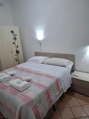 a bedroom with a bed with two towels on it at APARTAMENTO NAPOLEONe 38 in Rome