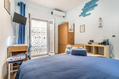 a bedroom with a blue bed and a window at Villa Up in Rome