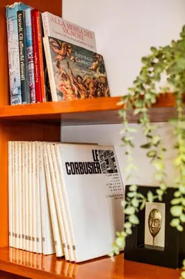 a book shelf with some books on it at Spanish Steps Luxury Apartment in Rome