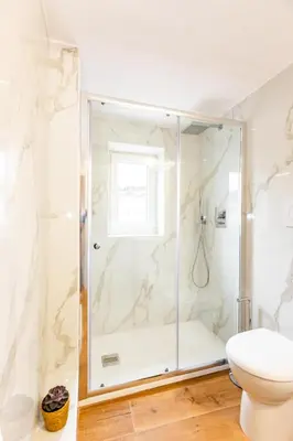 a bathroom with a shower and a toilet at Spanish Steps Luxury Apartment in Rome