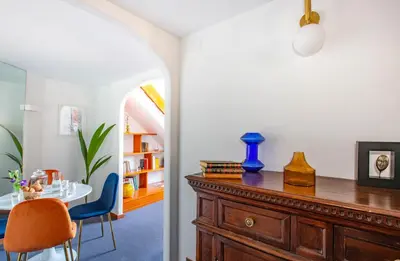 a dining room with a table and a wooden dresser at Spanish Steps Luxury Apartment in Rome