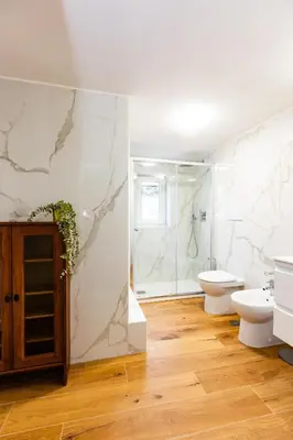 a bathroom with a toilet sink and a shower at Spanish Steps Luxury Apartment in Rome
