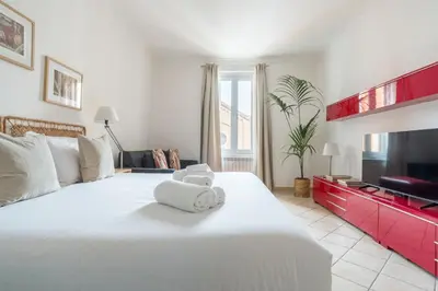 a bedroom with a large white bed with towels on it at Terrazza San Lorenzo - Luxury Apartment - Roma Centro in Rome