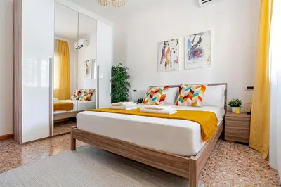 a bedroom with a large bed and a mirror at Casa Doria - ROMA in Rome