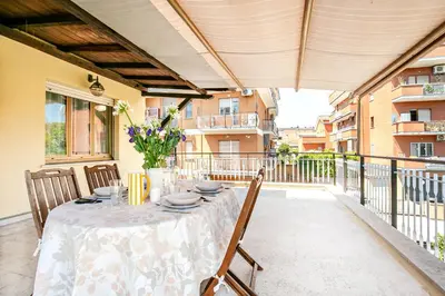a patio with a table and chairs on a balcony at Casa Doria - ROMA in Rome