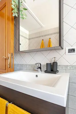 a white sink in a bathroom with a mirror at Casa Doria - ROMA in Rome