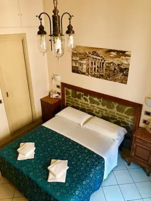 a bedroom with a bed with two pillows on it at Optimus B&B in Rome