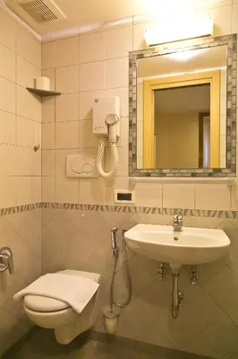 a bathroom with a sink and a toilet and a mirror at Optimus B&B in Rome