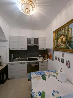 a kitchen with a sink and a stove top oven at Roomz Romestay in Rome