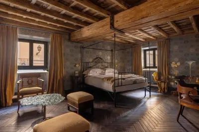 a bedroom with a canopy bed and a piano at Apppartamenti Vicolo degli Osti in Rome