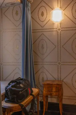 a bag is sitting on a table next to a wall at Apppartamenti Vicolo degli Osti in Rome