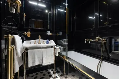 a black bathroom with a sink and a shower at Apppartamenti Vicolo degli Osti in Rome