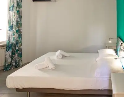 a hotel room with two rolled towels on a bed at St Peter Clivo 1 by BuddyRent in Rome