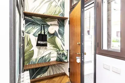 a hallway with a tropical leaf wallpaper at Italian Experience-Suite Trastevere in Rome