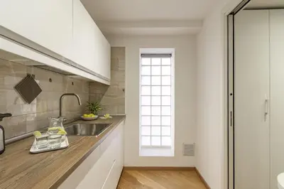 a kitchen with a sink and a window at Italian Experience-Suite Trastevere in Rome