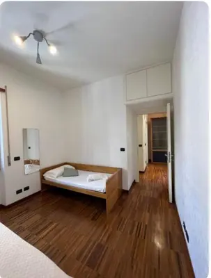 a bedroom with a bed and a wooden floor at Maison del Forte Boccea 108 in Rome