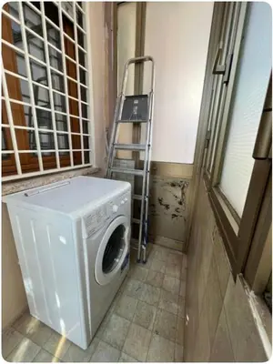 a washing machine in a laundry room with a ladder at Maison del Forte Boccea 108 in Rome