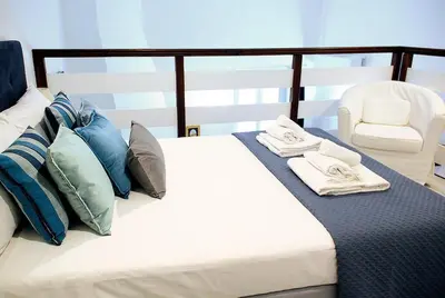 a bedroom with a bed with pillows and a chair at Trevi 88 in Rome