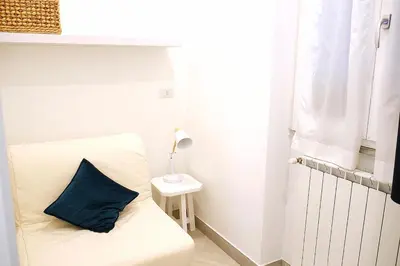 a room with a bed with a blue pillow on it at Trevi 88 in Rome