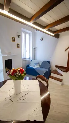 a living room with a table and a blue couch at Trevi 88 in Rome