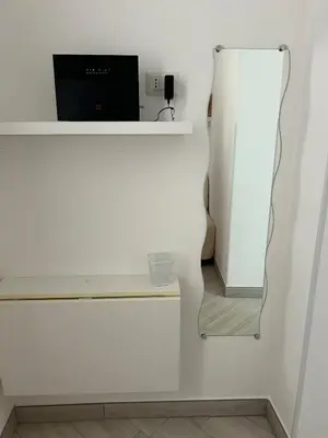 a white wall with a desk with a computer on it at Trevi 88 in Rome