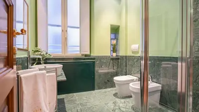 a bathroom with two toilets and two sinks at Marble House 7 in Rome
