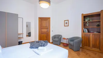 a bedroom with a white bed and two chairs at Marble House 7 in Rome