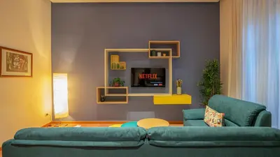a living room with a couch and a tv at Marble House 7 in Rome