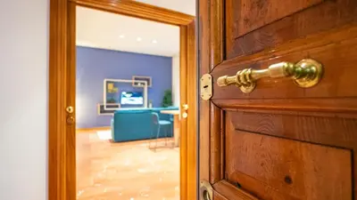 a wooden door with a mirror in a room at Marble House 7 in Rome