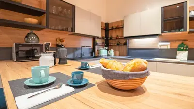 a kitchen with a bowl of bread on a table at Marble House 7 in Rome
