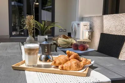 a table with a tray of croissants and a glass of milk at Urban Oasis near Termini, free Parking&Patio, int3 in Rome