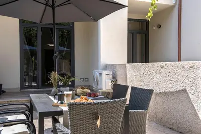 a table and chairs with an umbrella on a patio at Urban Oasis near Termini, free Parking&Patio, int3 in Rome