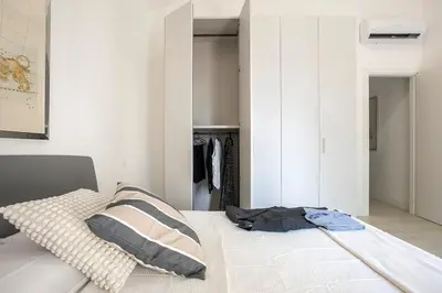 a bedroom with a bed and a closet at Urban Oasis near Termini, free Parking&Patio, int3 in Rome