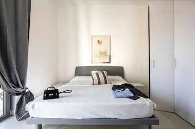 a bedroom with a large white bed in a room at Urban Oasis near Termini, free Parking&Patio, int3 in Rome