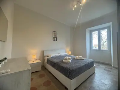 a bedroom with a bed with two towels on it at Rome Ostiense Apartment in Rome