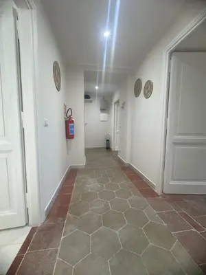 a hallway with a tile floor and a white door at Rome Ostiense Apartment in Rome