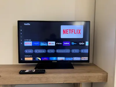 a television sitting on a table with a remote control at Rome Ostiense Apartment in Rome