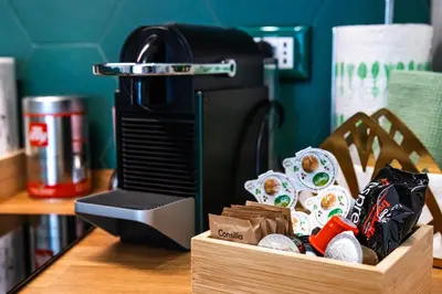 a coffee maker and a box of sushi on a table at Casa Fen Palazzo Storico - Re di Roma metro A - 2camere2bagni in Rome
