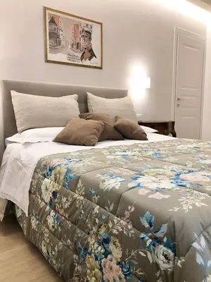 a bedroom with a large bed with a floral blanket at Casa di Corto in Rome