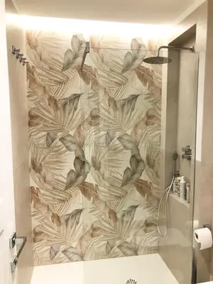 a bathroom with a shower with a wall at Casa di Corto in Rome