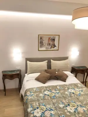 a bedroom with a large bed with two tables at Casa di Corto in Rome