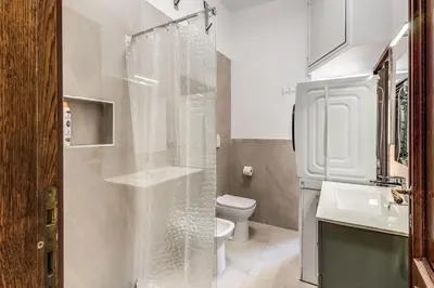 a white bathroom with a toilet and a shower at Vatican Eagle Rooms in Rome